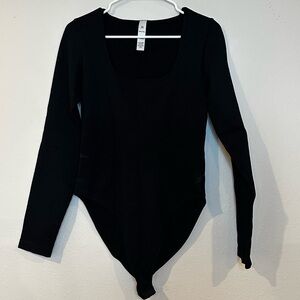 Women’s black size extra large, long sleeve body suit snap crotch.